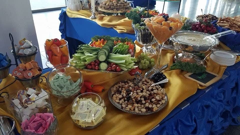 A buffet table with a variety of fruits and vegetables on it