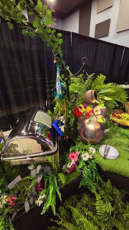 A table with a lot of plants and flowers on it.