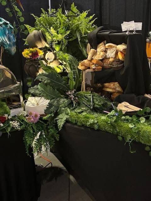 A table with a bunch of bread and flowers on it