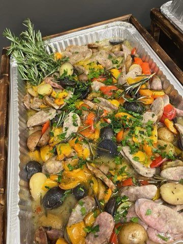 A tray of food with meat and vegetables on a table.