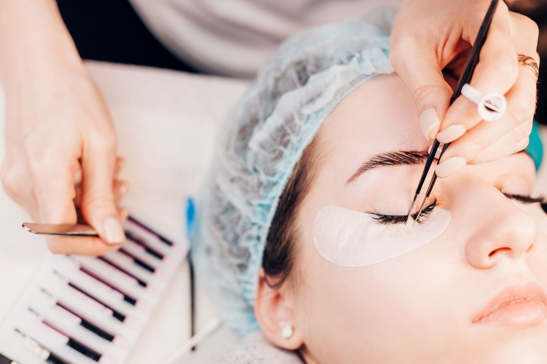 a woman is getting her eyelashes done at a beauty salon