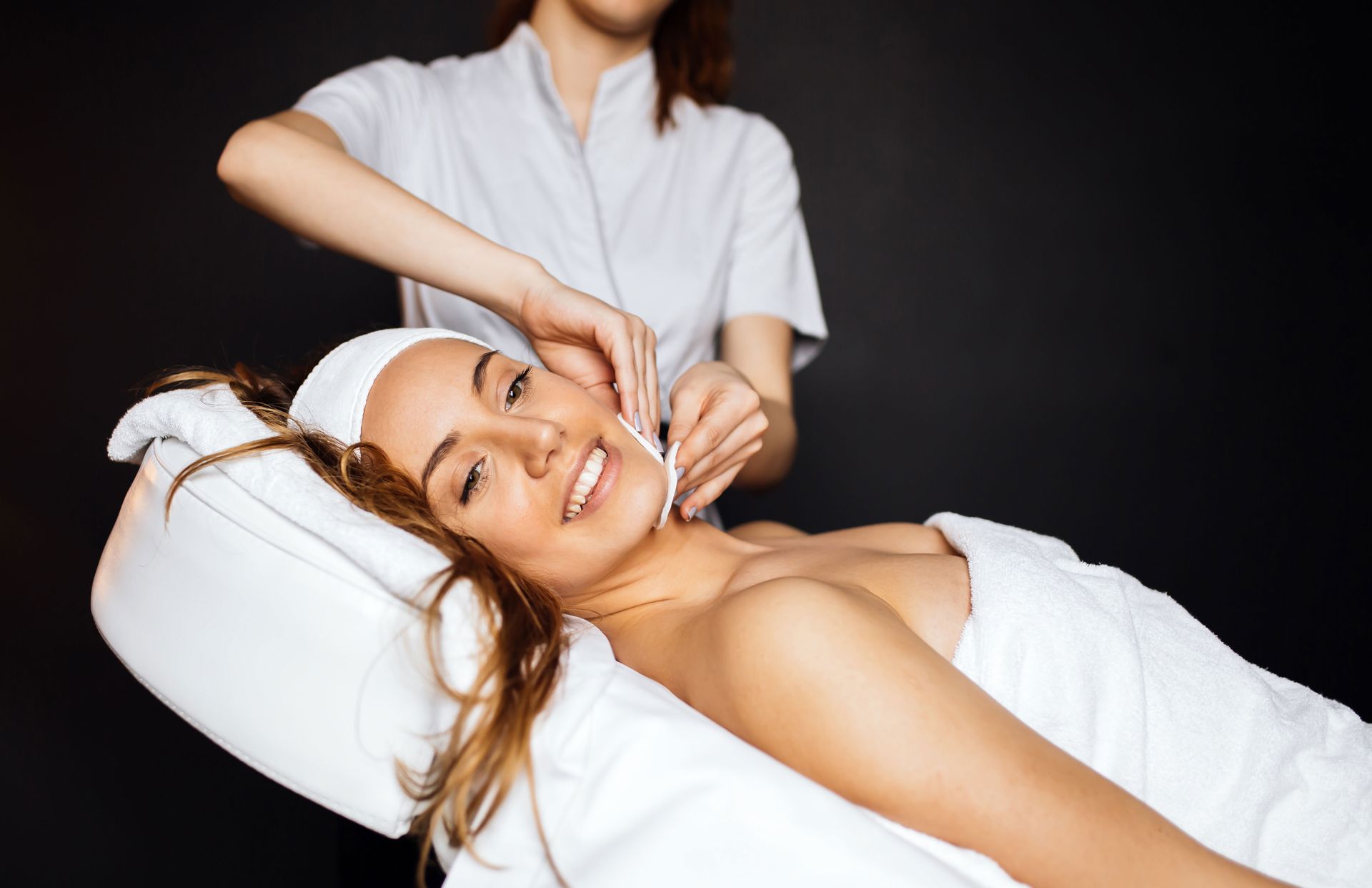 A woman is getting a facial treatment at a spa.