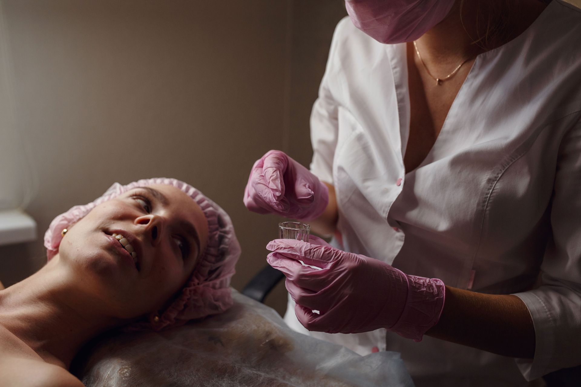 A woman is getting a facial treatment at a beauty salon.