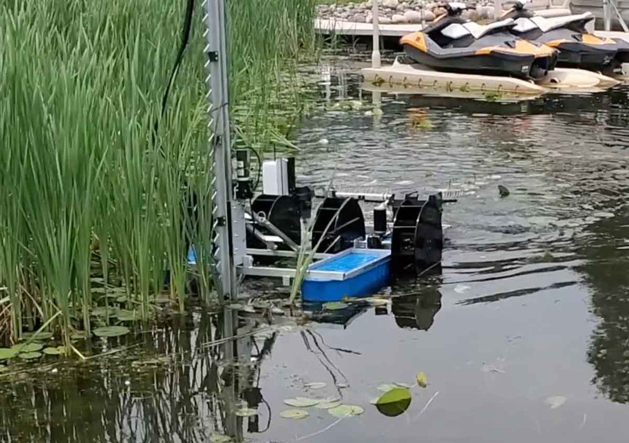 A boat is floating on top of a body of water next to a dock.