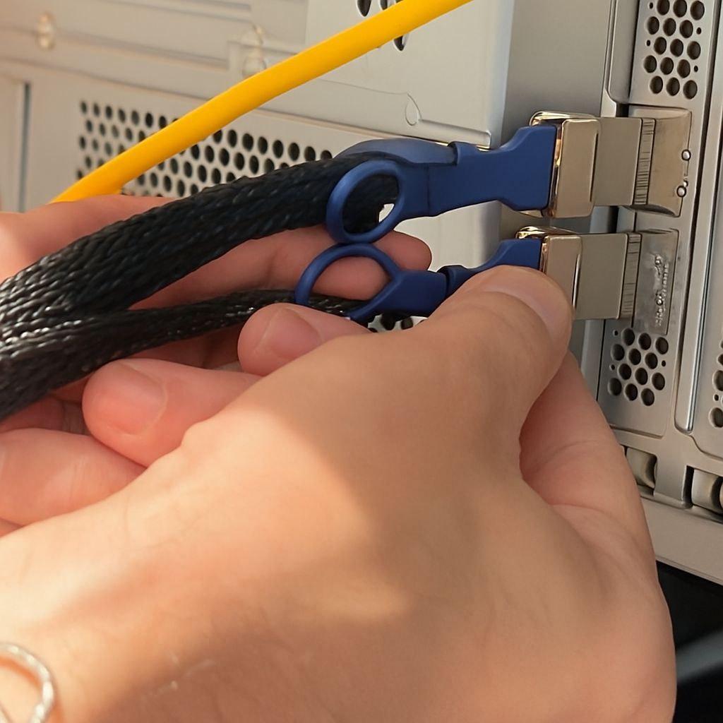 Fadi Helou, Network Infrastructure Specialist, connecting 100 Gbps fiber uplink cables to an enterprise server during a high-speed network installation by CALLIT IT INFRASTRUCTURE in Dubai.
Caption: