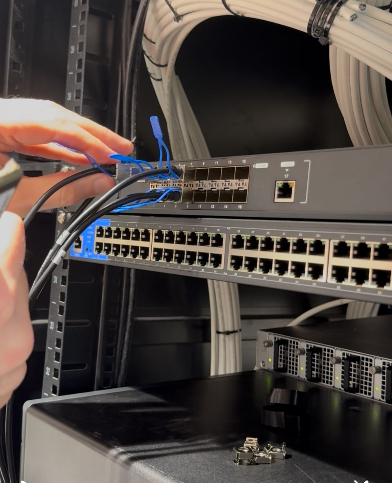 Fadi Helou configuring managed network switches with structured cabling during enterprise network installation by CALLIT IT INFRASTRUCTURE in Dubai, UAE.