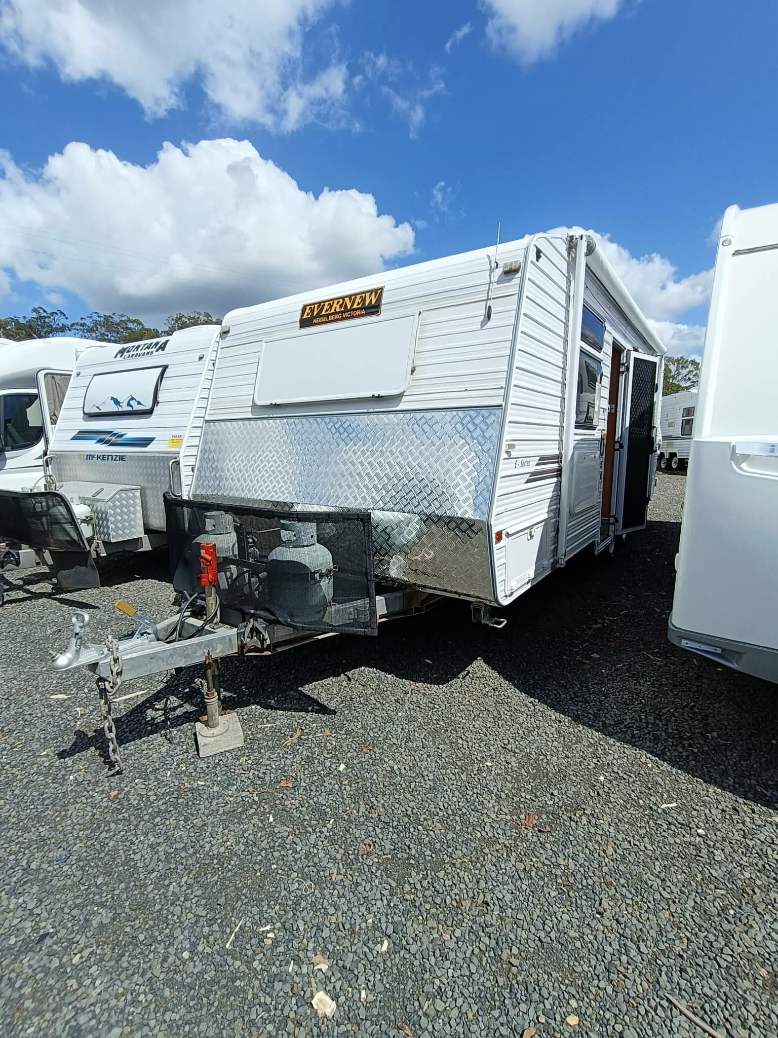 White Caravan With Silver Front, Parked Outdoors on Gravel — Great Lakes Caravans & RV P/L In Nabiac, NSW