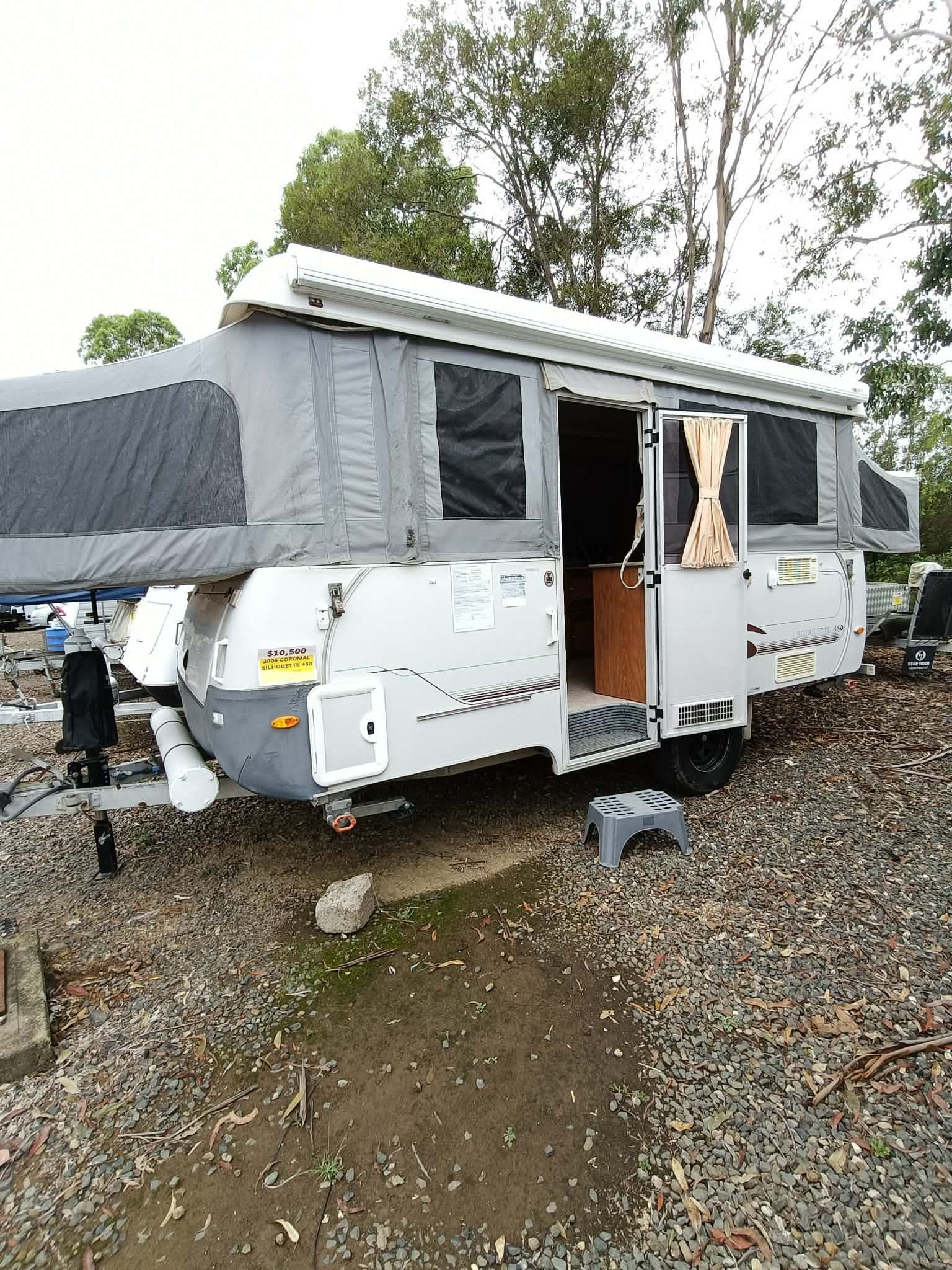 A Light Gray Pop-up Camper With the Top Extended, Parked on Gravel — Great Lakes Caravans & RV P/L In Nabiac, NSW