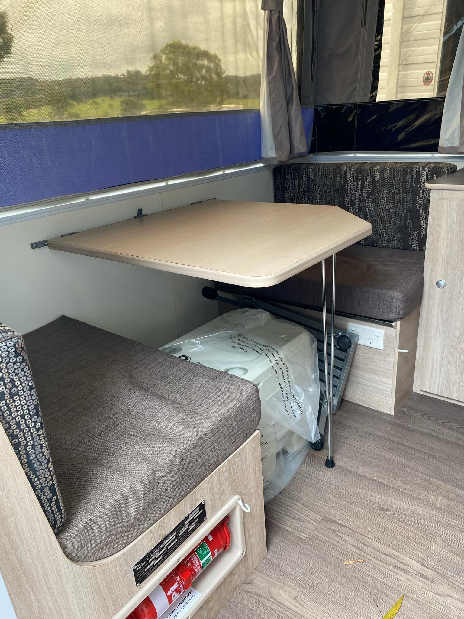 Interior of a Camper With a Table and Seating — Great Lakes Caravans & RV P/L In Maitland, NSW