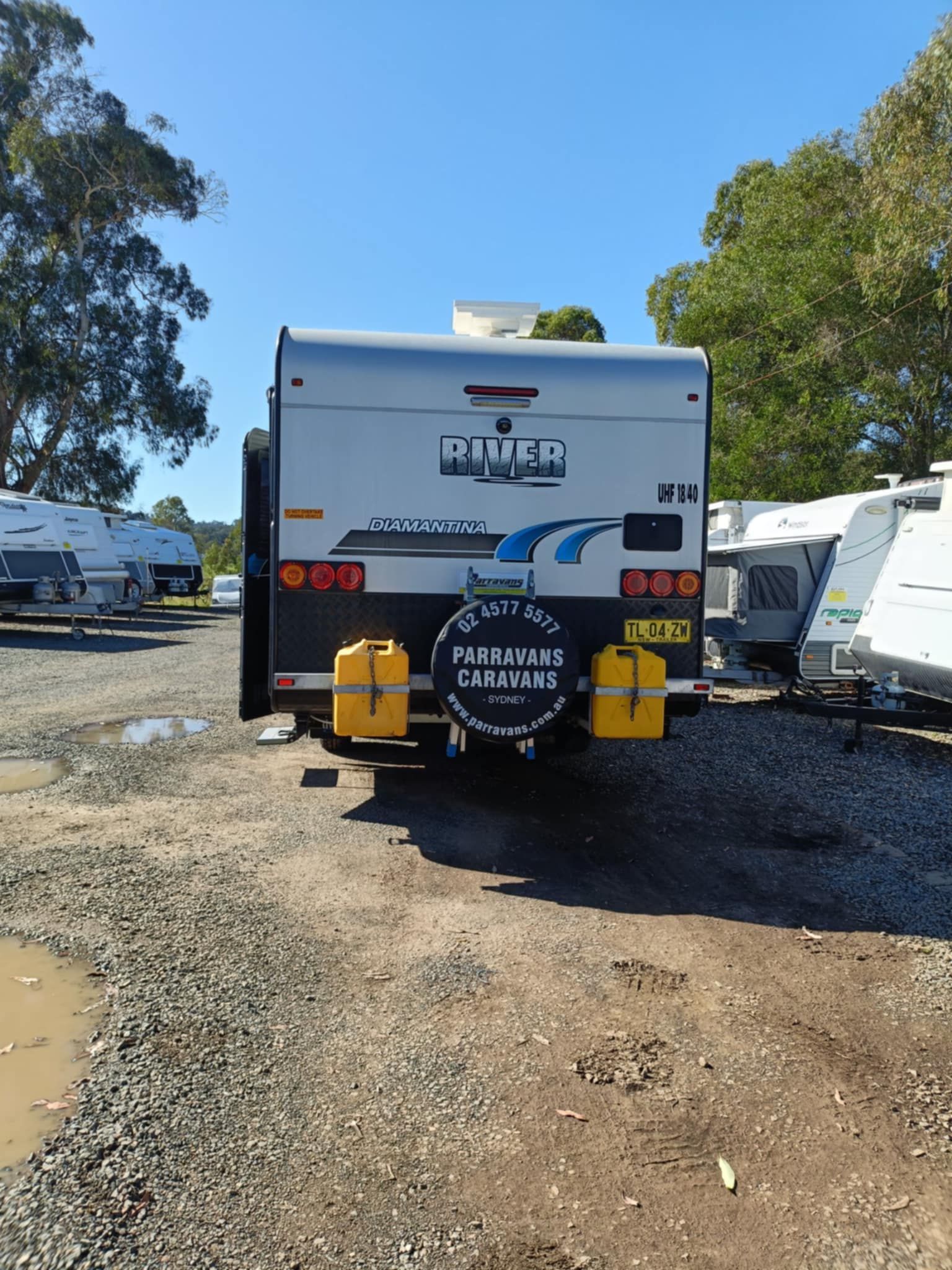 Rear View of a Silver Caravan With Spare Tire — Great Lakes Caravans & RV P/L In Taree, NSW