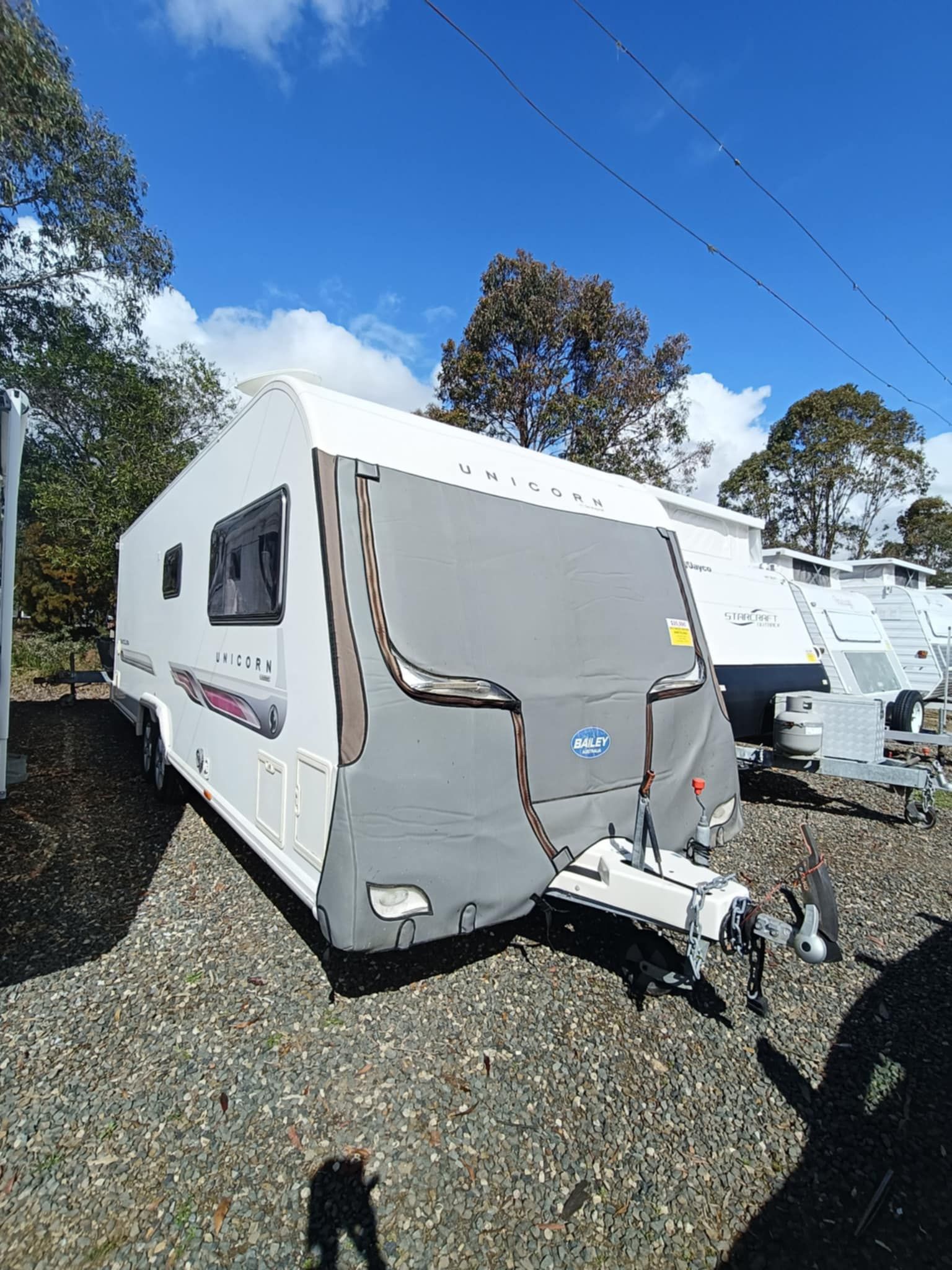 White and Grey Caravan Parked on Gravel — Great Lakes Caravans & RV P/L In Mid North Coast, NSW