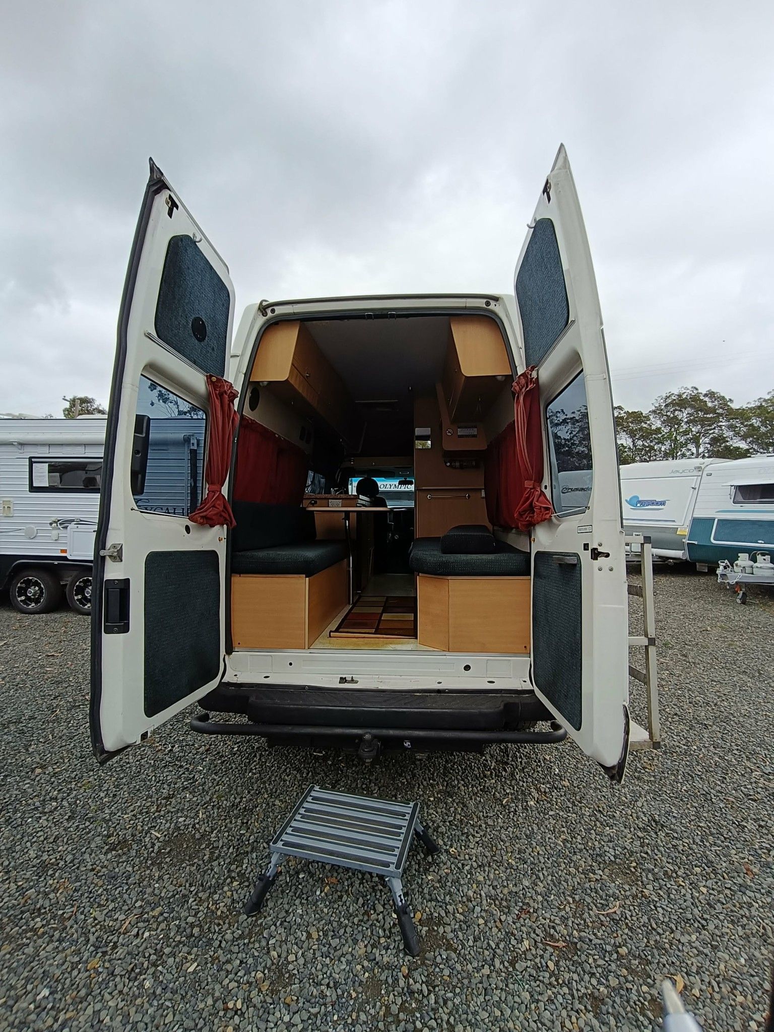 Back of a White Camper Van With Doors Open — Great Lakes Caravans & RV P/L In Port Macquarie, NSW