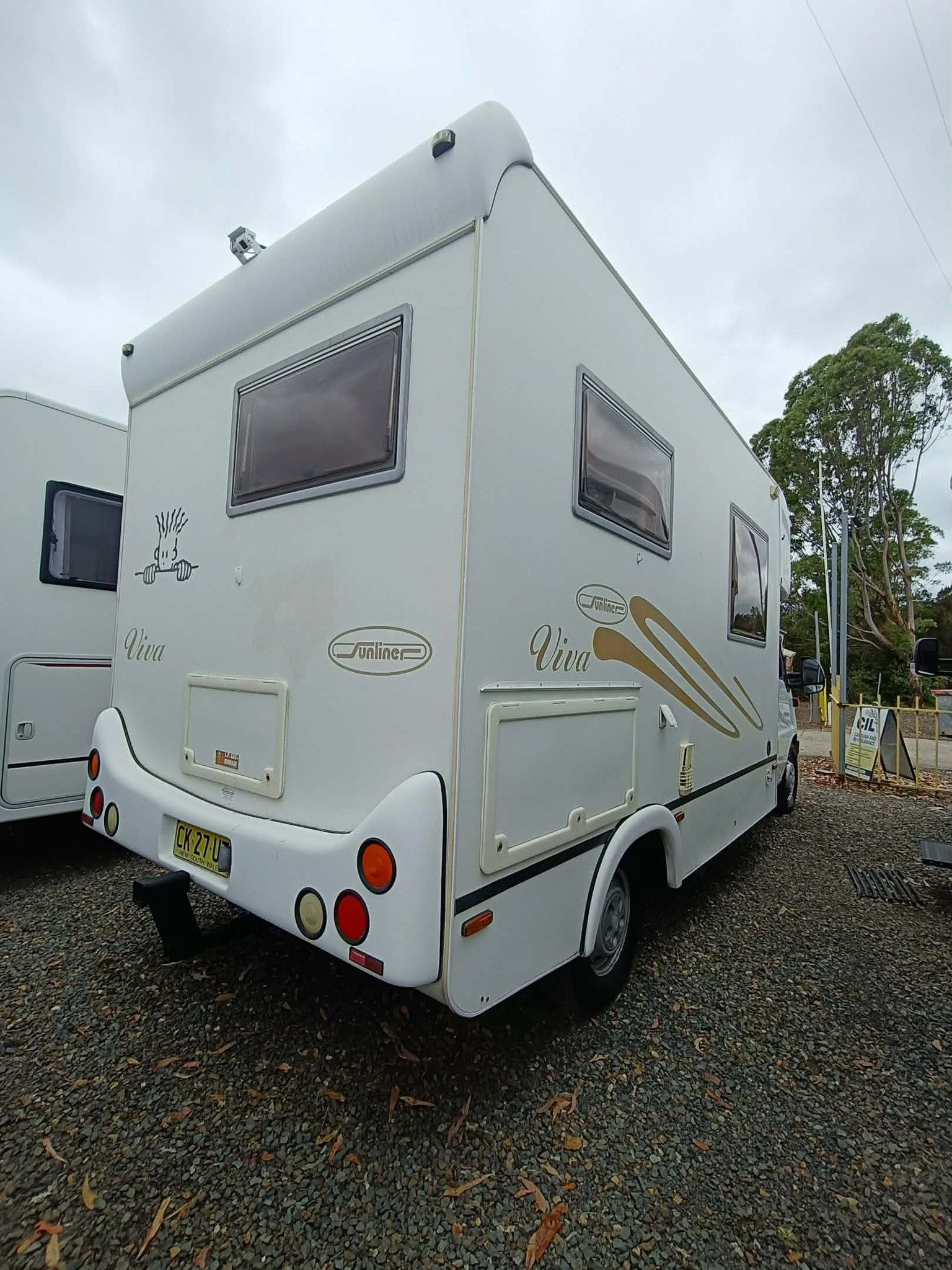White Campervan Parked on Gravel — Great Lakes Caravans & RV P/L In Taree, NSW