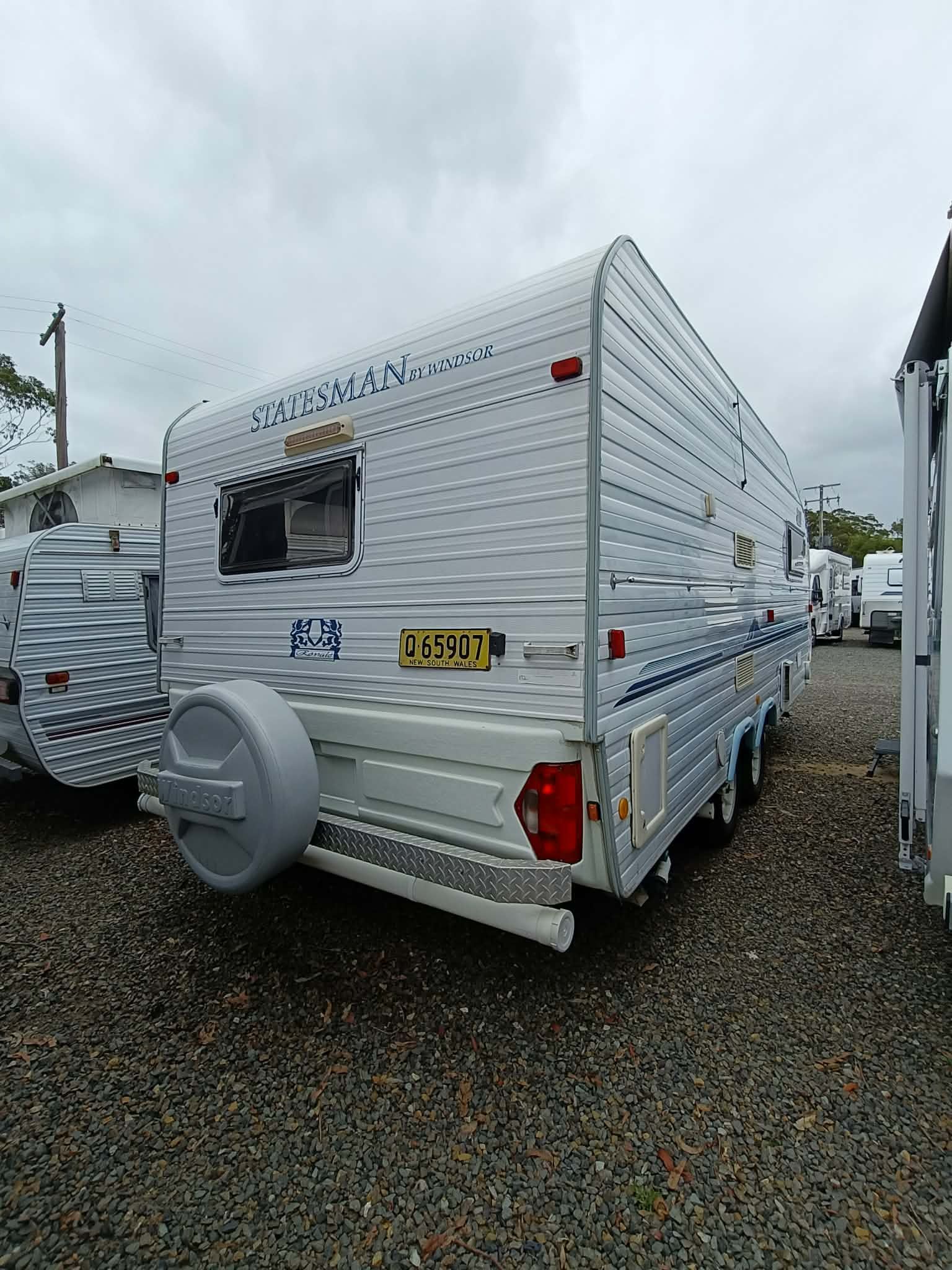 Rear View of a Silver Caravan Parked on Gravel — Great Lakes Caravans & RV P/L In Nabiac, NSW