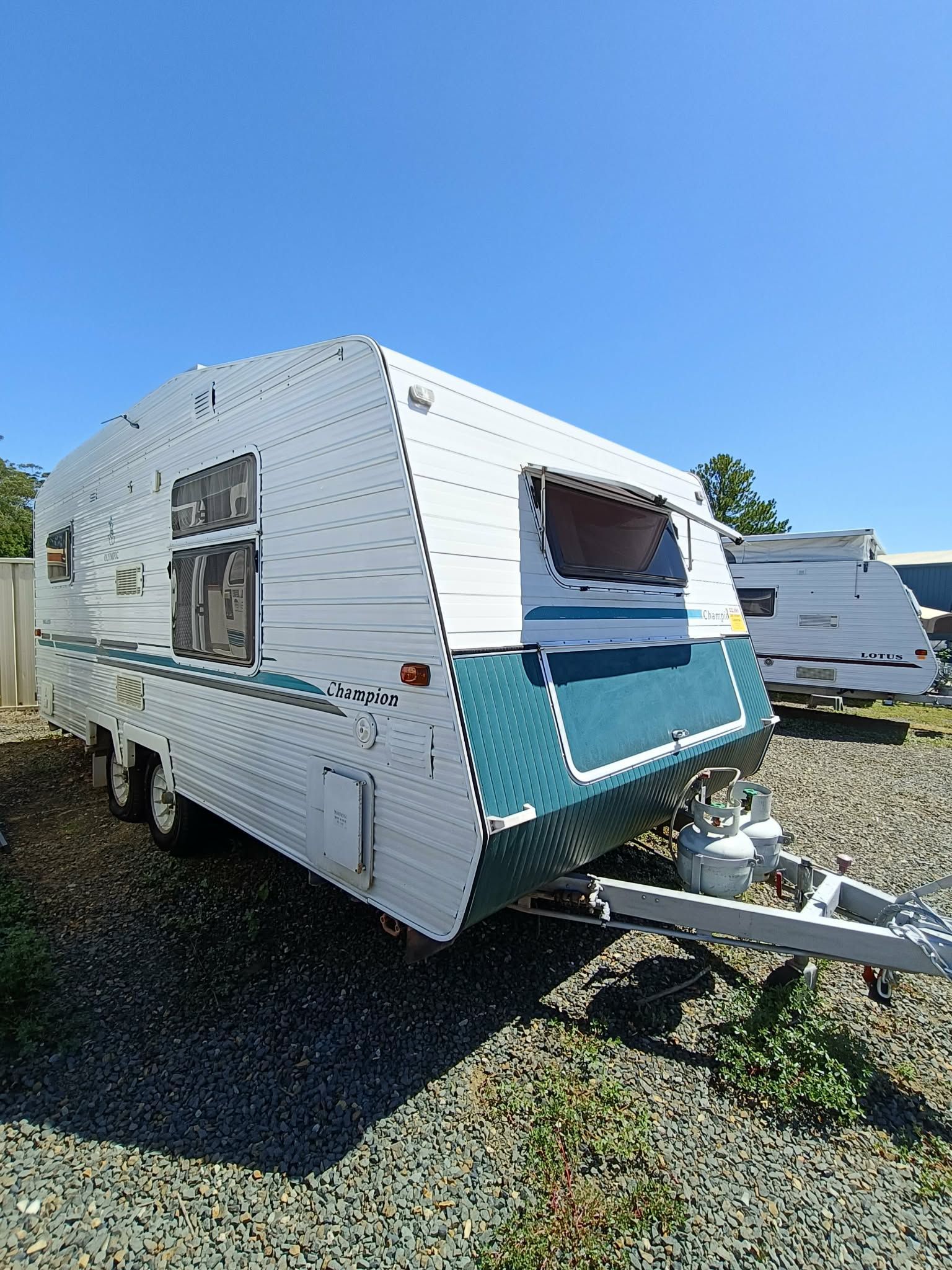White and Teal Travel Trailer on Gravel — Great Lakes Caravans & RV P/L In Maitland, NSW
