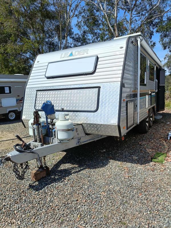 Silver Leader Caravan Parked on Gravel, With a White Roof and Propane Tanks — Great Lakes Caravans & RV P/L In Nabiac, NSW