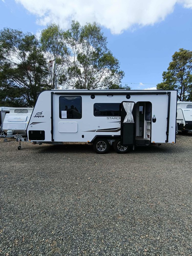 White Travel Trailer Parked on Gravel, Open Door — Great Lakes Caravans & RV P/L In Nabiac, NSW