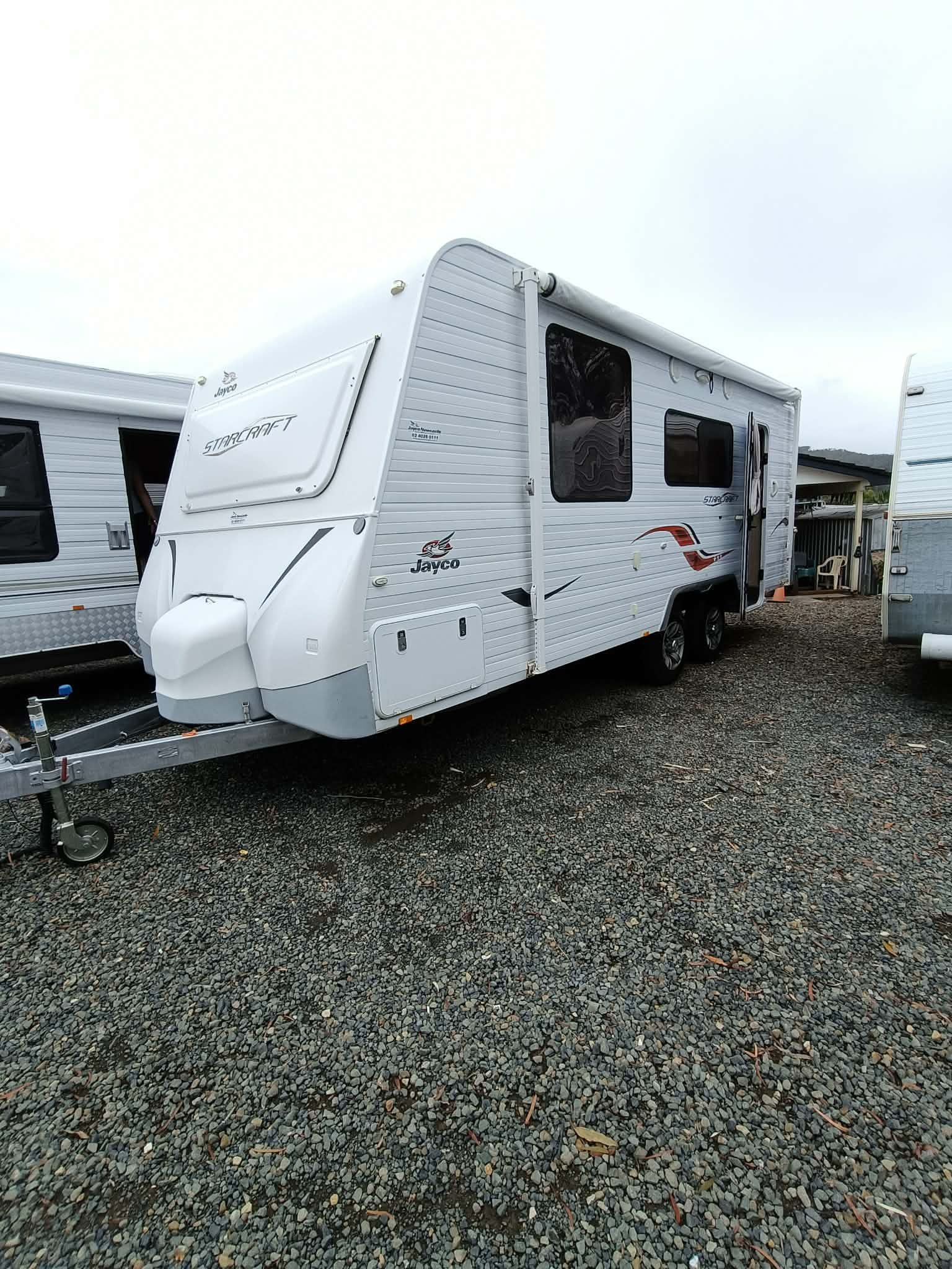White Travel Trailer Parked on Gravel, With Closed Awning — Great Lakes Caravans & RV P/L In Nabiac, NSW