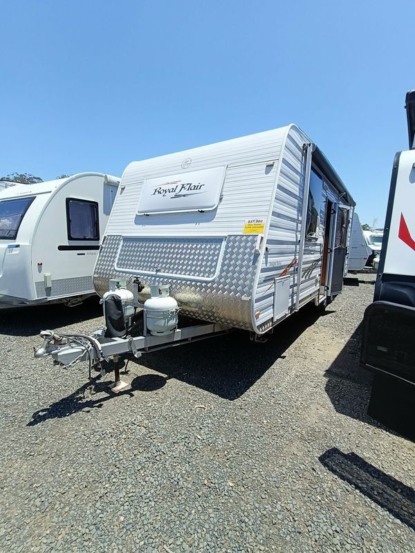 A White and Silver Royal Flair Caravan Parked on Gravel — Great Lakes Caravans & RV P/L In Nabiac, NSW