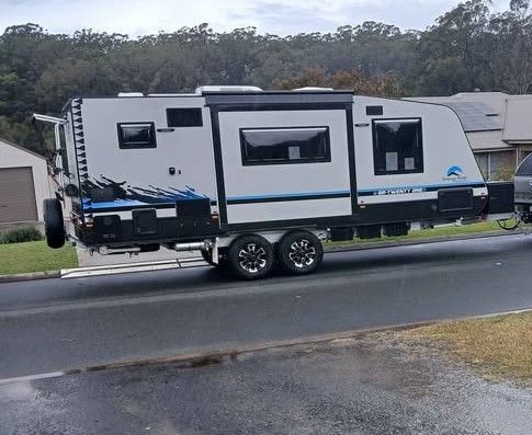 A Caravan With Blue and White Accents Parked on a Paved Road — Great Lakes Caravans & RV P/L In Nabiac, NSW