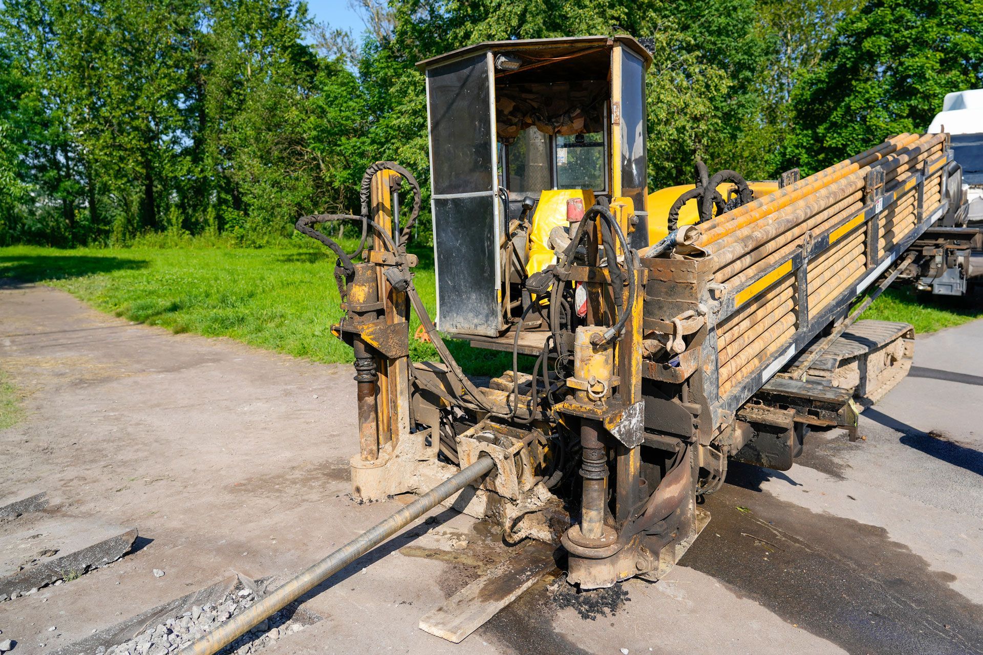 Drilling rig spraying water and slurry on concrete ground