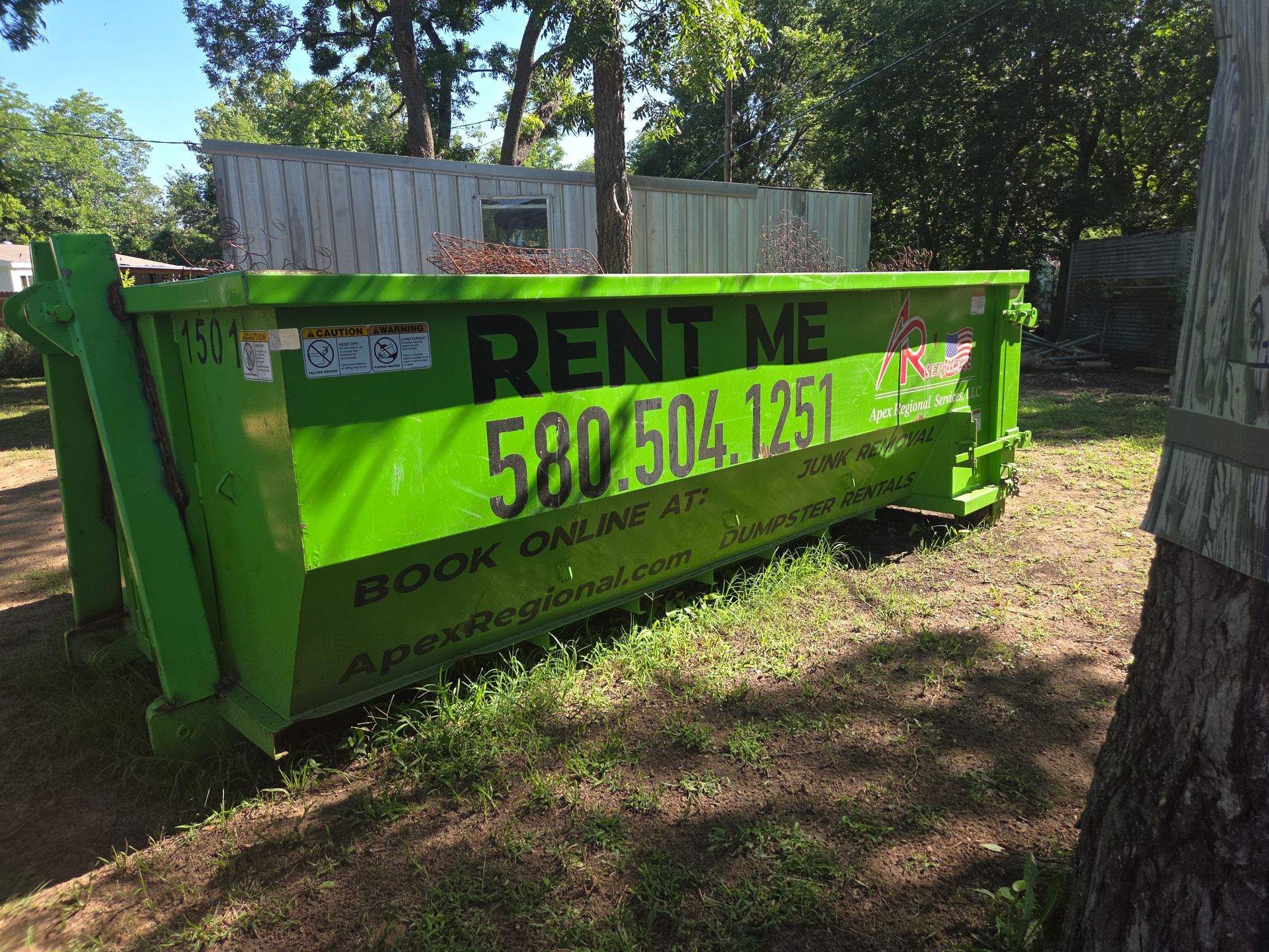Bright green dumpster with 