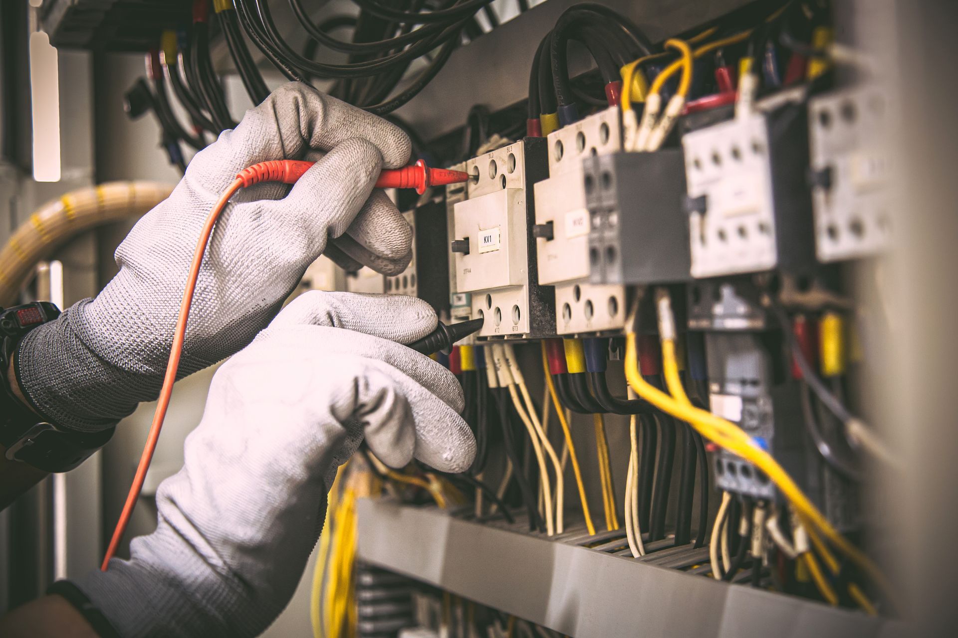 an electrician is working on an electrical circuit breaker with a multimeter .