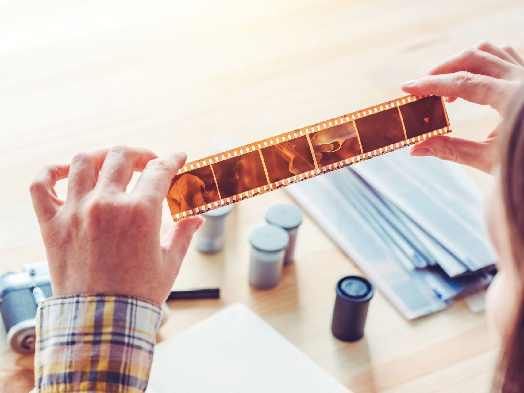 a person is holding a roll of film in their hands .