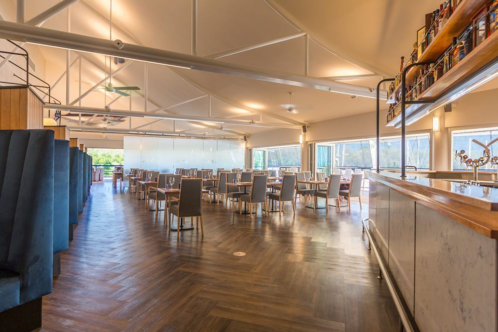 A Large Dining Room with Tables and Chairs and a Bar — Cairns Excel Electrics In Bungalow, QLD