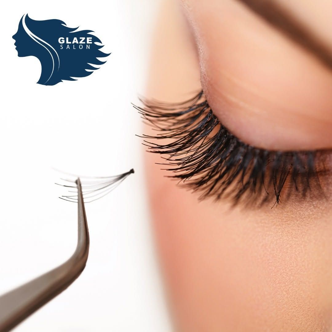 A close-up of an eye with lush, long black eyelashes