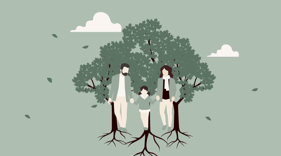 Eine Familie steht unter einem Baum mit Wurzeln.