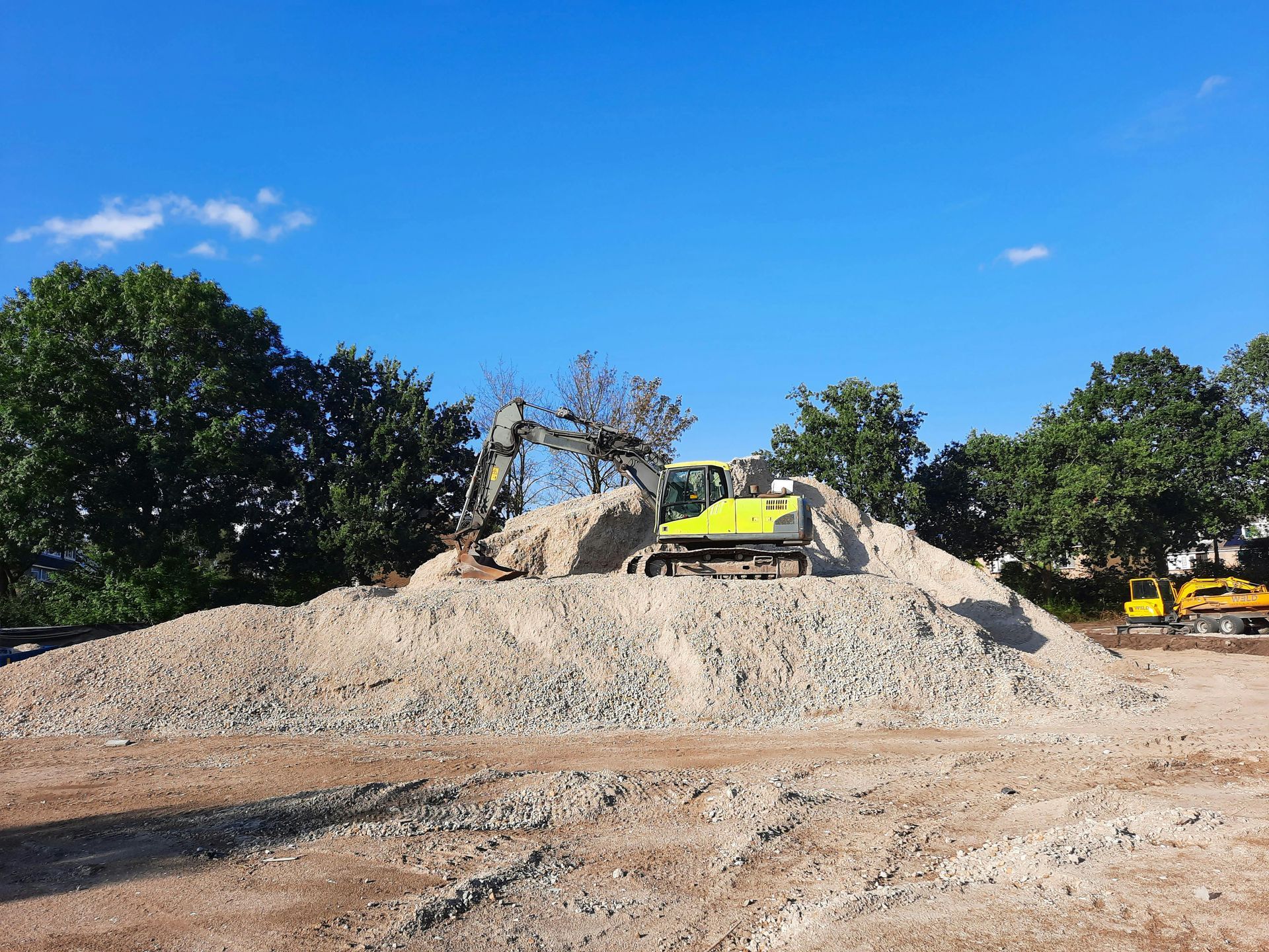 A man is operating an excavator on a construction site.