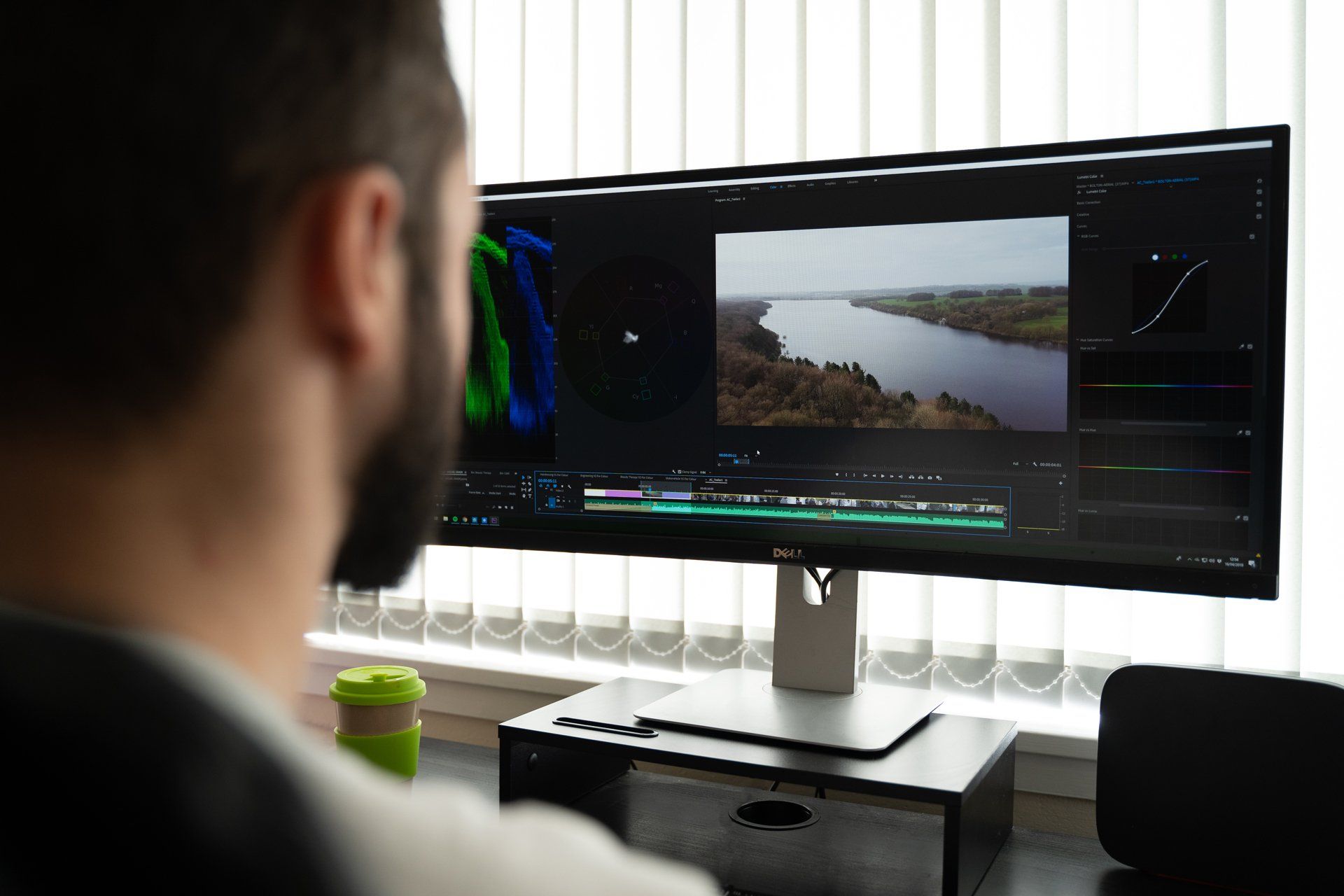 A man is looking at a computer screen with a river on it.