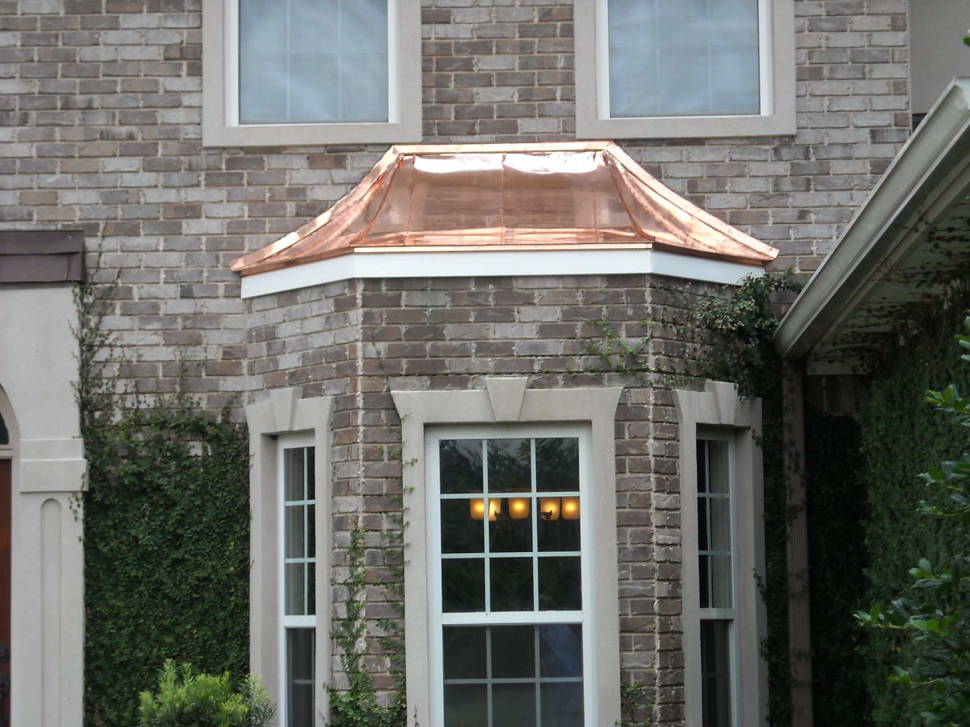 A Brick Building With A Window And A Copper Roof — Richmond Hill, GA — A Plus