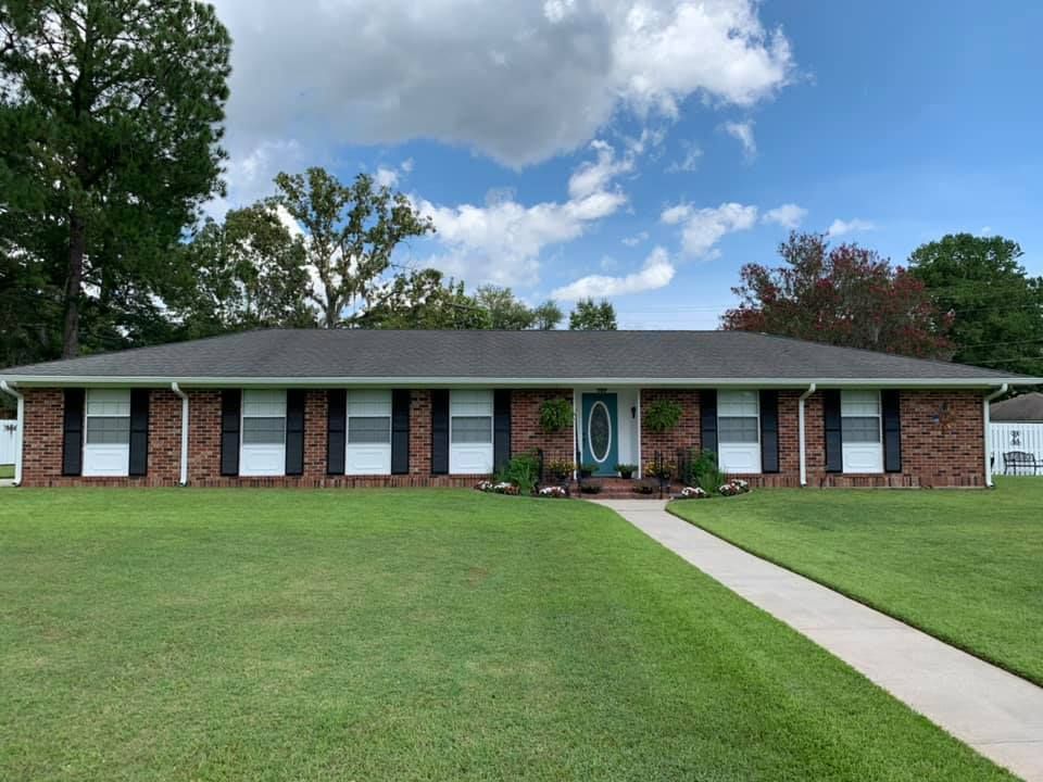 A Brick House With Black Shutters And A Green Door — Richmond Hill, GA — A Plus