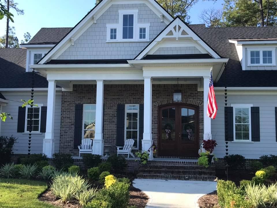 The Front Of A House With A Flag On The Porch — Richmond Hill, GA — A Plus