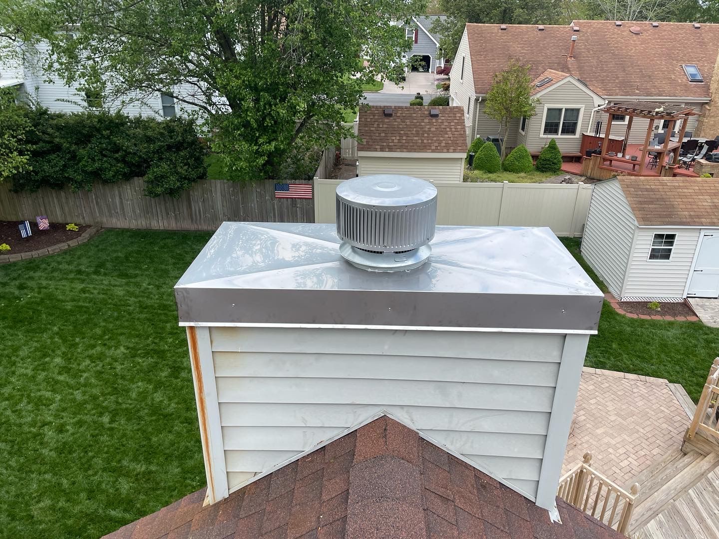 An aerial view of a chimney on the roof of a house.