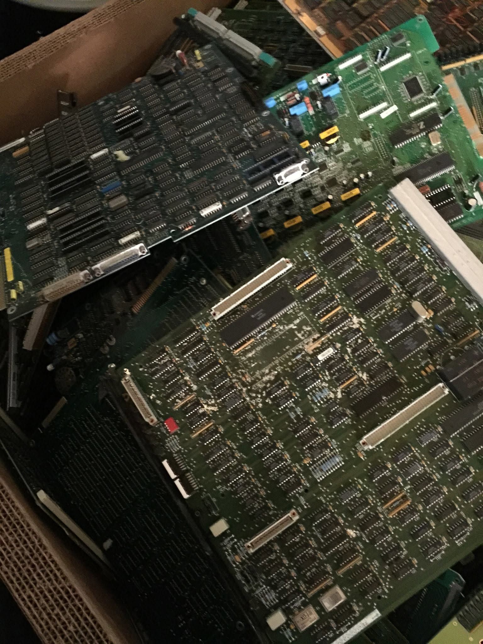 Two green circuit boards with black components inside a box.