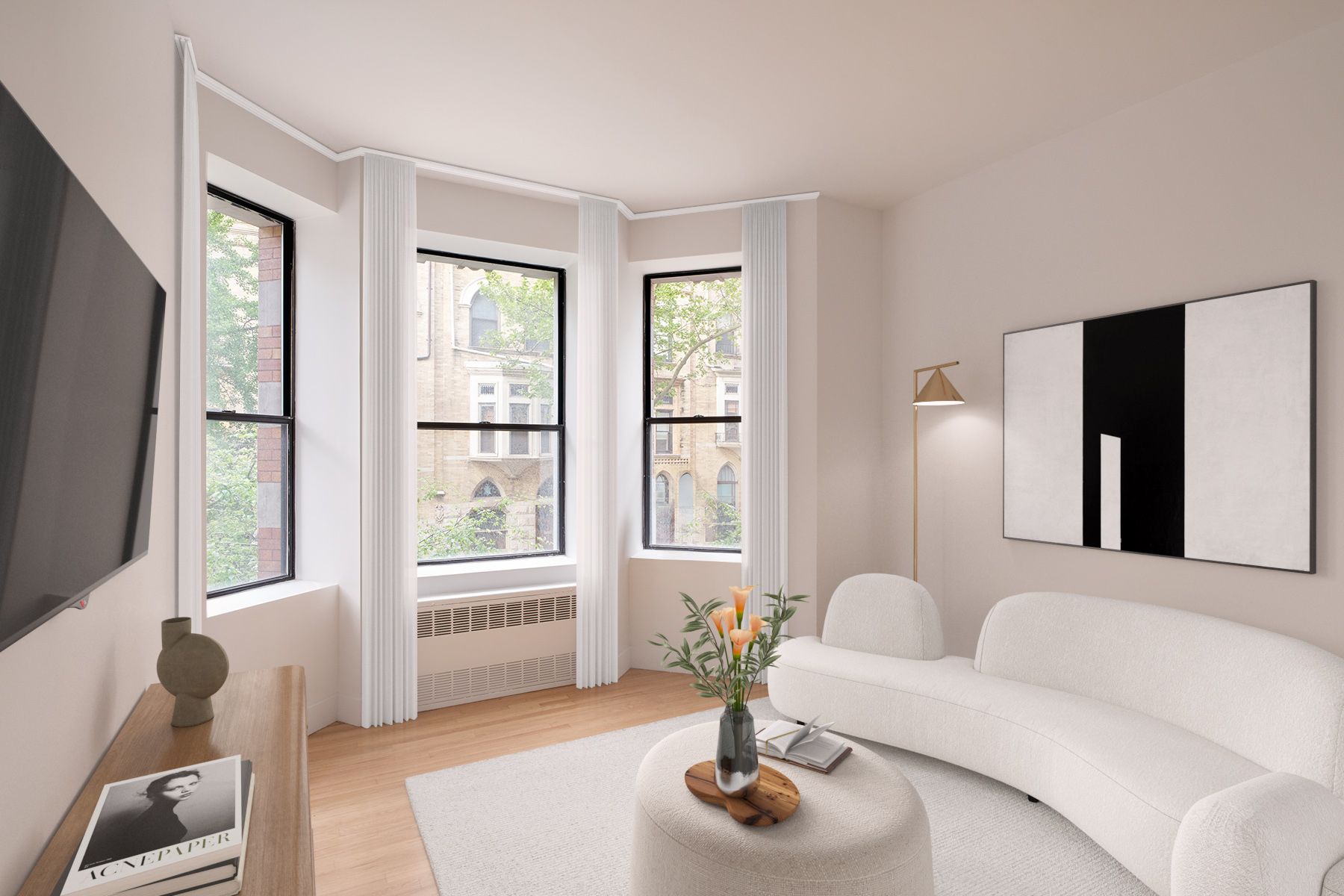 A living room with a white couch and a flat screen tv