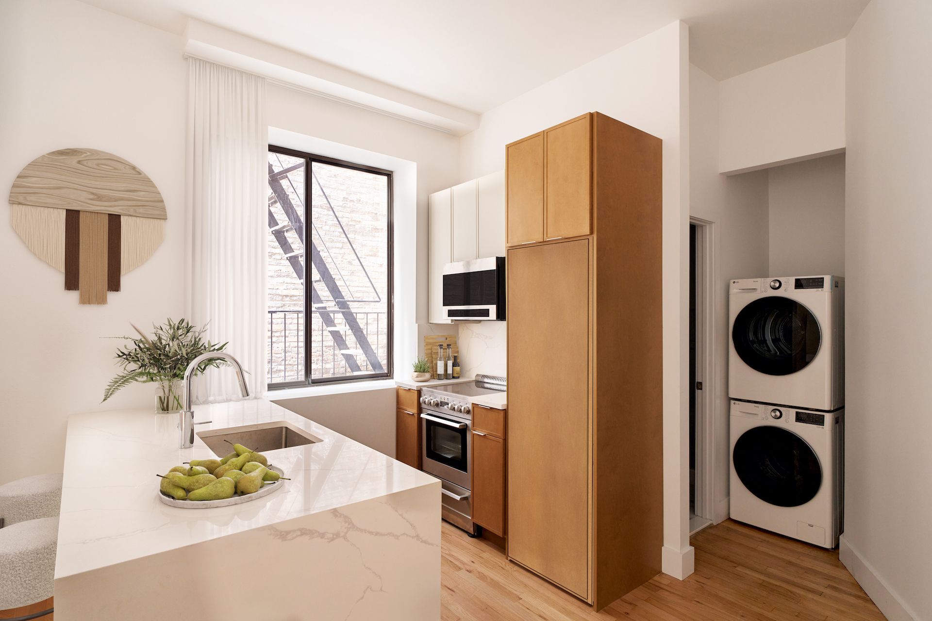 A kitchen with a washer and dryer stacked on top of each other.