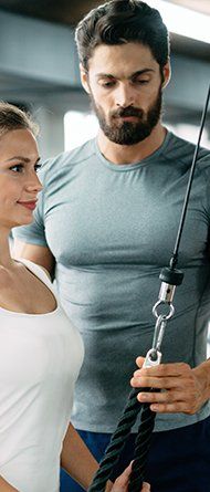 Female doing yoga while watching yoga videos on her laptop