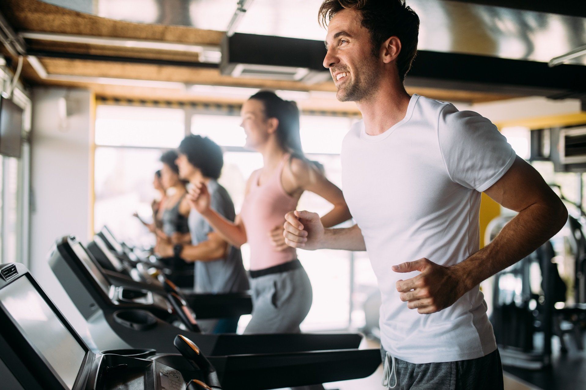 A group of people using a treadmill