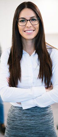 Female smiling into the camera with three people behind her
