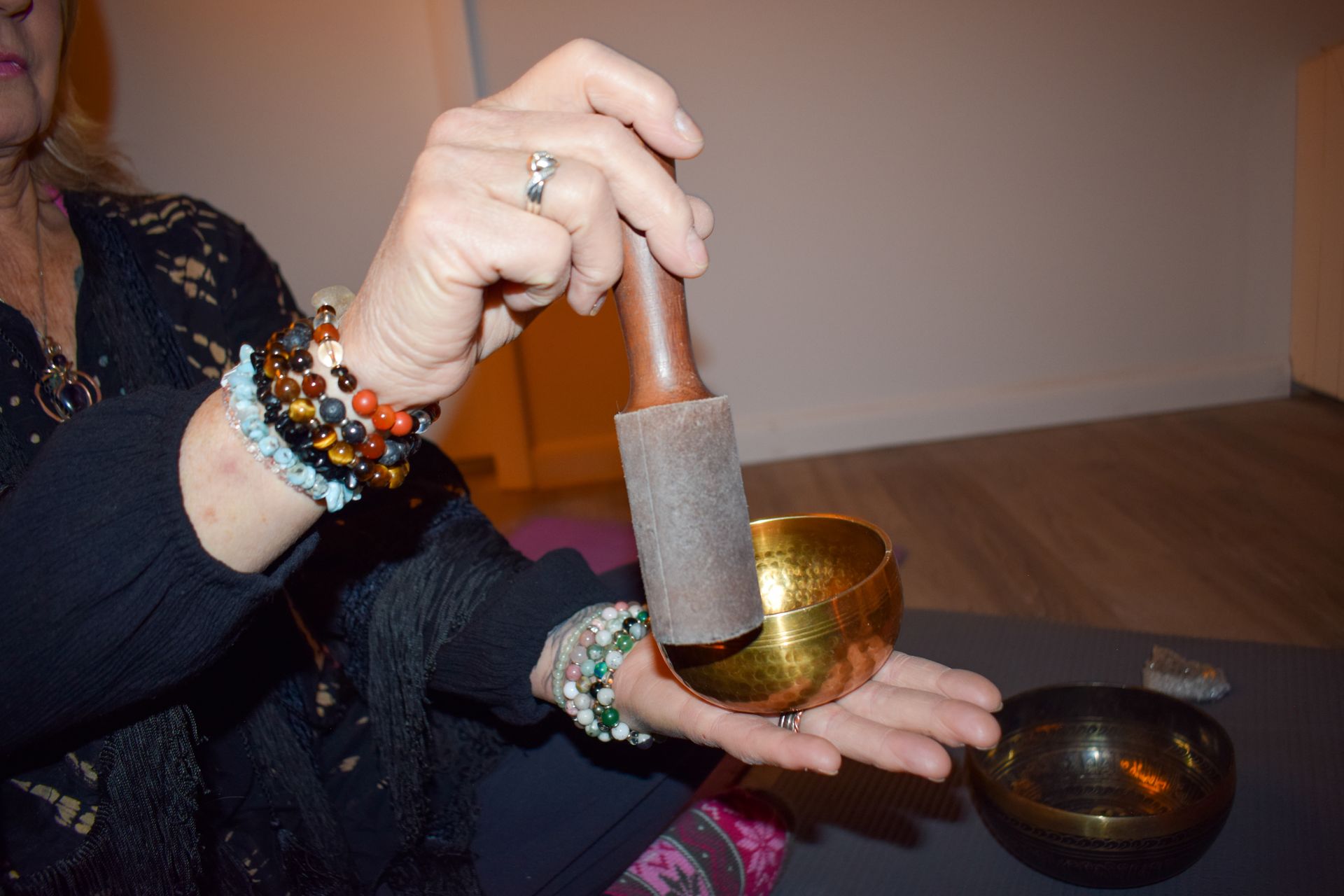 Hand with jewelry using sound bowl