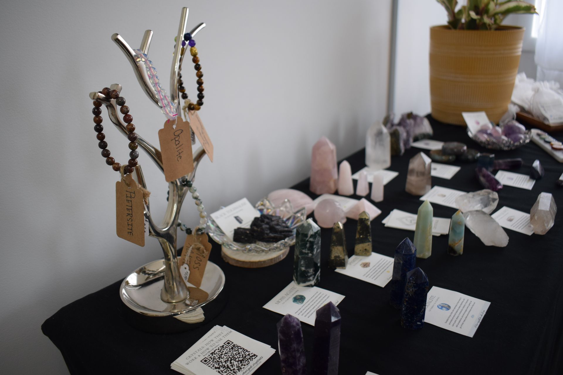 A table with a lot of crystals and bracelets on it