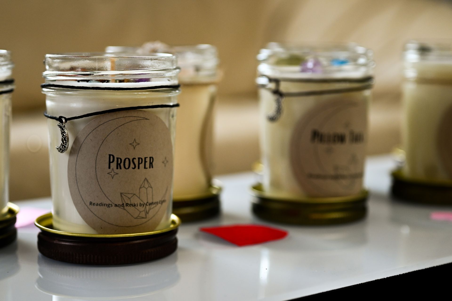 Four jars of candles with the word prosper on them