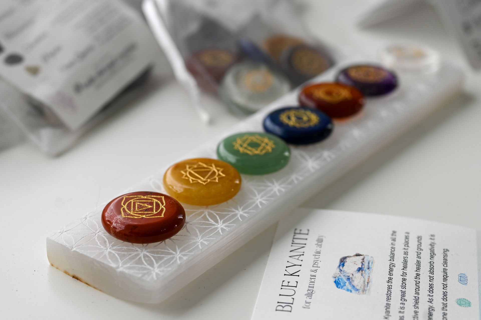 A set of chakra stones sitting on top of a white tray.