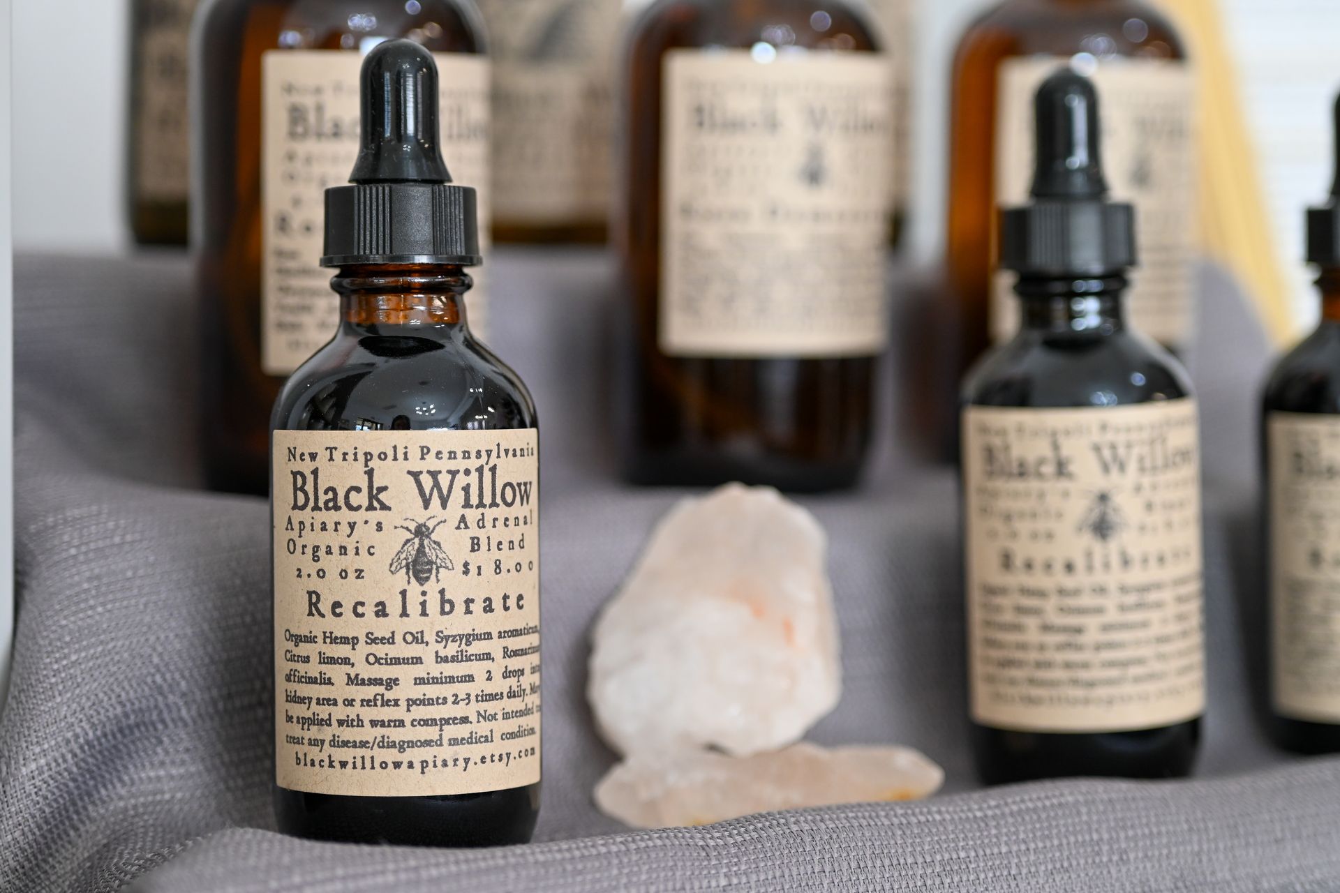 Several bottles of black willow are sitting on a table