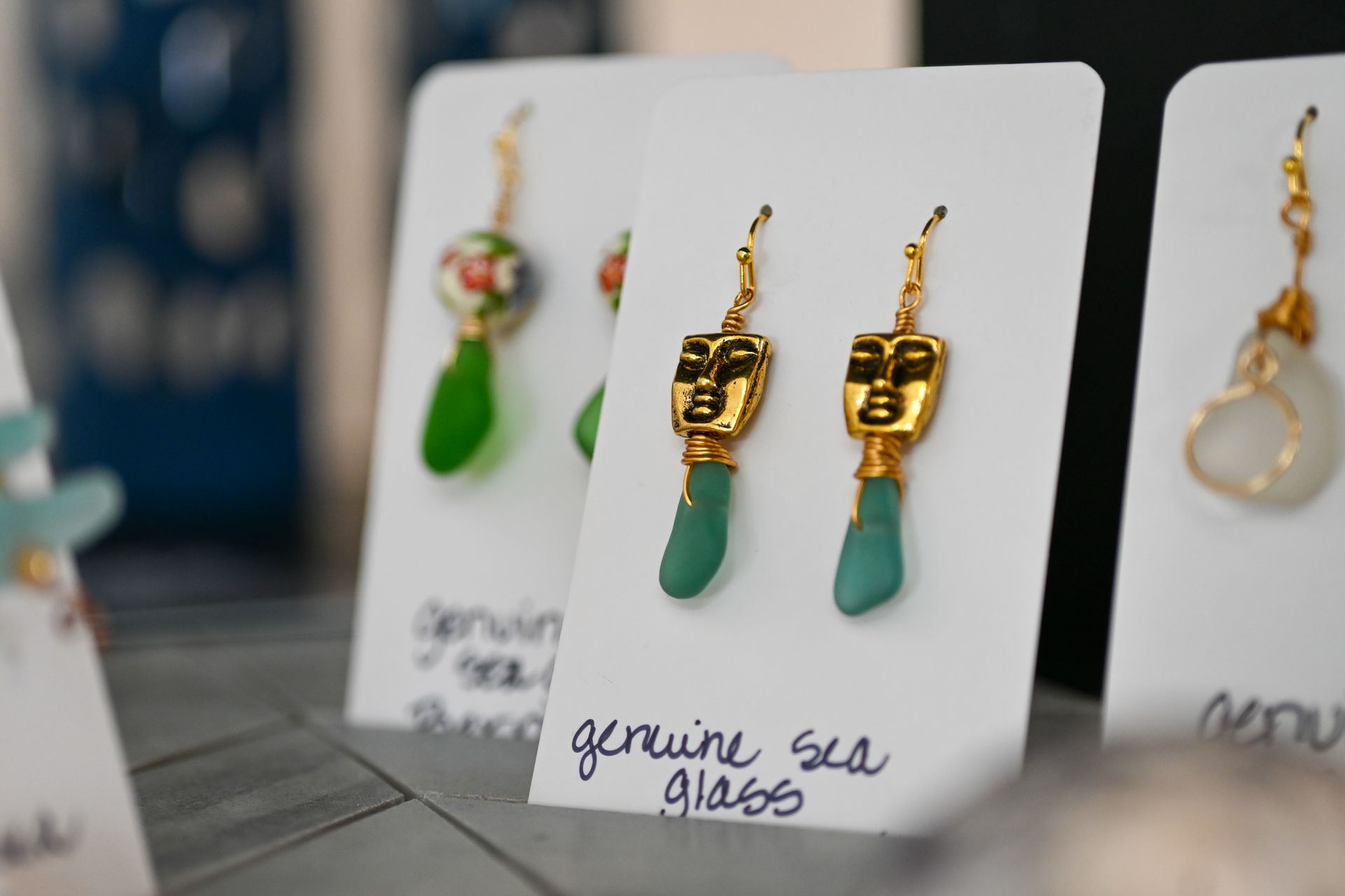A pair of genuine sea glass earrings on a card