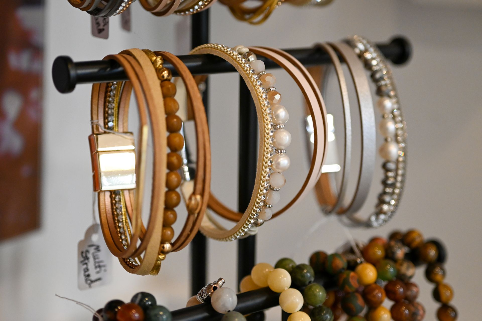 A variety of bracelets are displayed on a rack